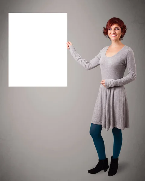 Young woman presenting white paper copy space — Stock Photo, Image