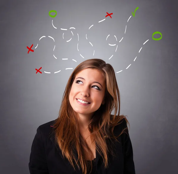 Young woman thinking with abstract marks overhead — Stock Photo, Image