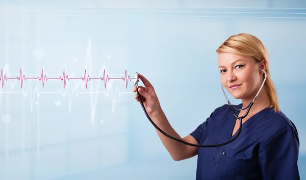 Pretty medical doktor listening to red pulse and heart rates — Stock Photo, Image