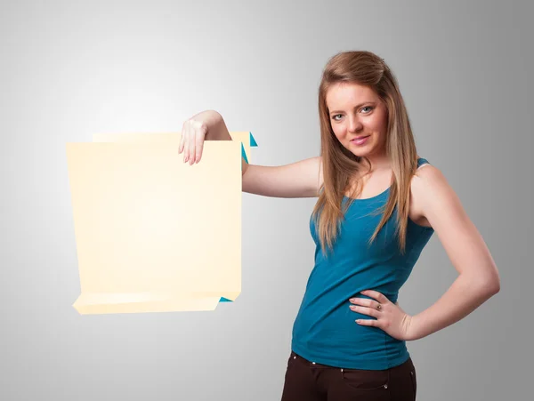 Young woman holding white origami paper copy space — Stock Photo, Image