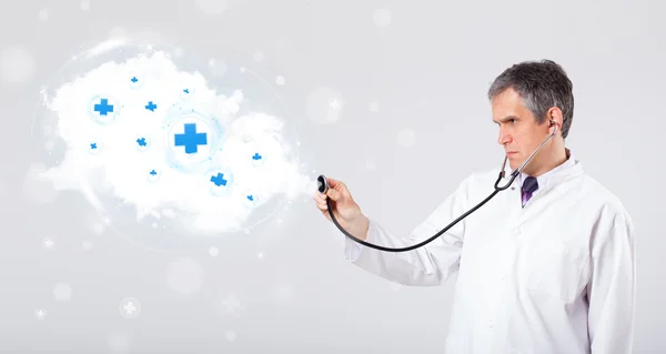 Doctor listening to abstract cloud with medical signs — Stock Photo, Image