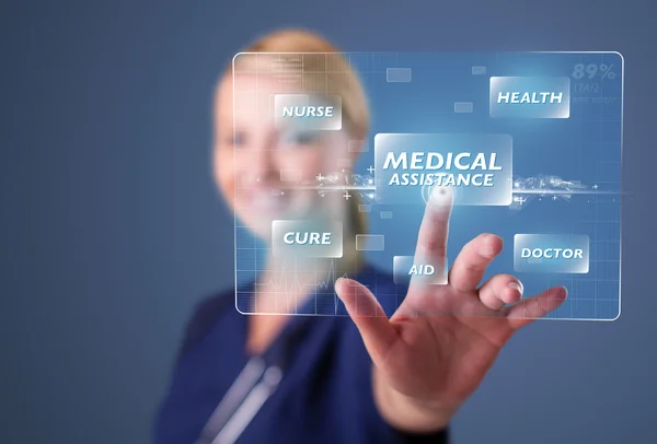 Young nurse pressing modern medical type of buttons — Stock Photo, Image