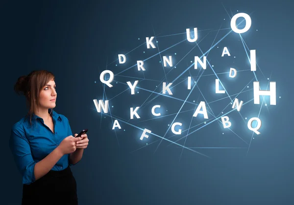 Young woman typing on smartphone with high tech 3d letters commi — Stock Photo, Image