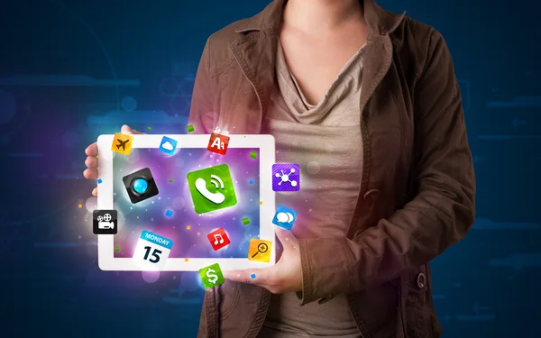 Lady holding a tablet with modern colorful apps and icons — Stock Photo, Image