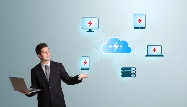 Young man holding a laptop and presenting cloud computing networ — Stock Photo, Image