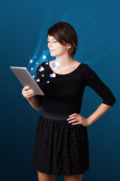 Young woman looking at modern tablet with abstract lights and so — Stock Photo, Image