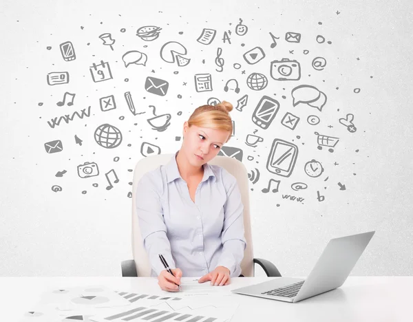 Young businesswoman with all kind of hand-drawn media icons in b — Stock Photo, Image