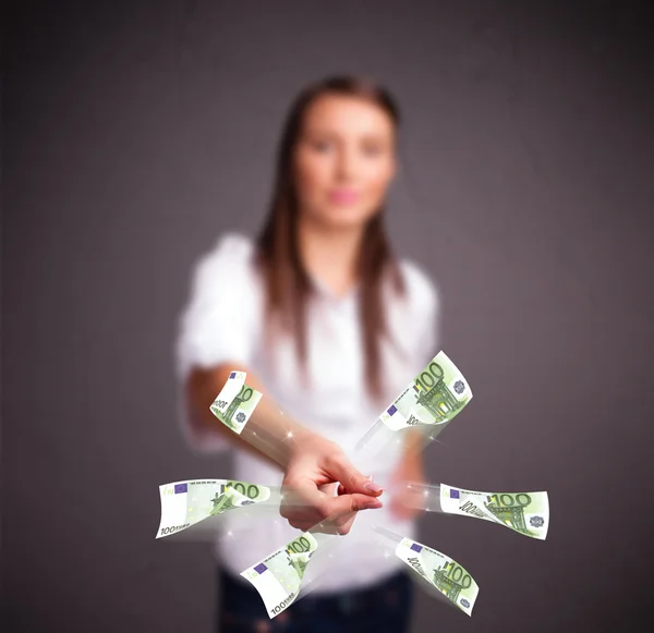 Pretty woman standing and throwing money — Stock Photo, Image
