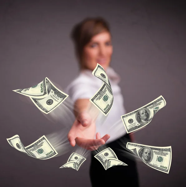 Young girl throwing money — Stock Photo, Image