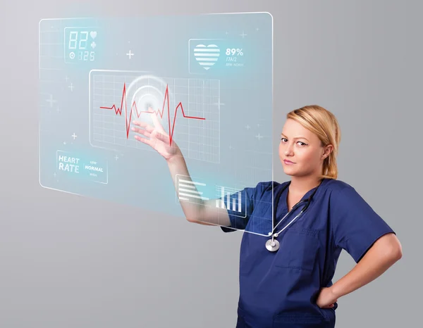 Young nurse pressing modern medical type of buttons — Stock Photo, Image