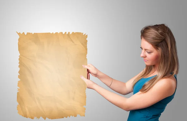 Young girl presenting old paper copy space — Stock Photo, Image