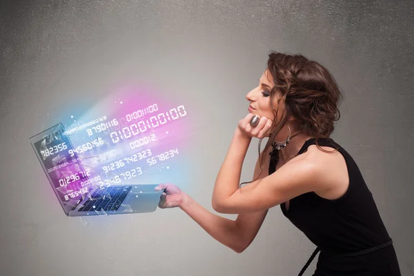 Casual woman holding laptop with exploding data and numers — Stock Photo, Image