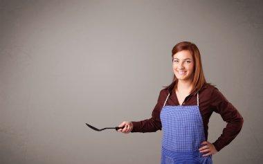 Güzel bir kadın kaşık tutuyor.