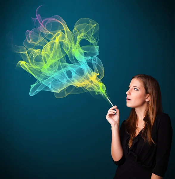 Pretty lady smoking cigarette with colorful smoke — Stock Photo, Image