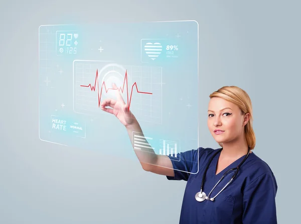 Young nurse pressing modern medical type of buttons — Stock Photo, Image