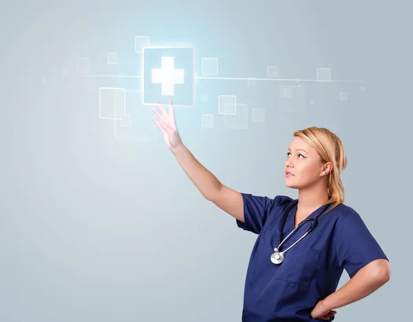 Young nurse pressing modern medical type of buttons — Stock Photo, Image