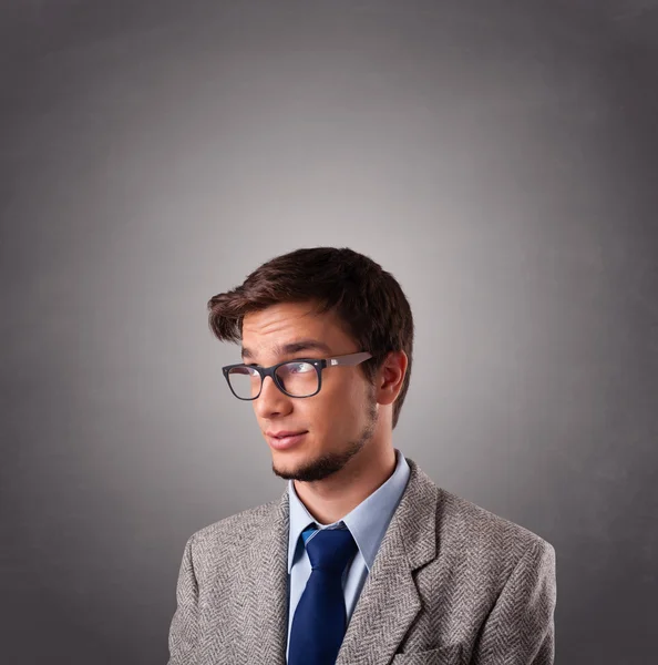 Attractive young man standing and thinking with copy space — Stock Photo, Image