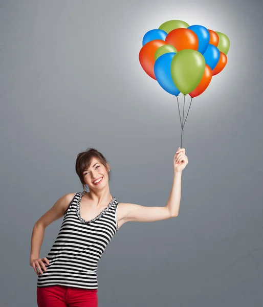 Young woman holding colorful balloons — Stock Photo, Image