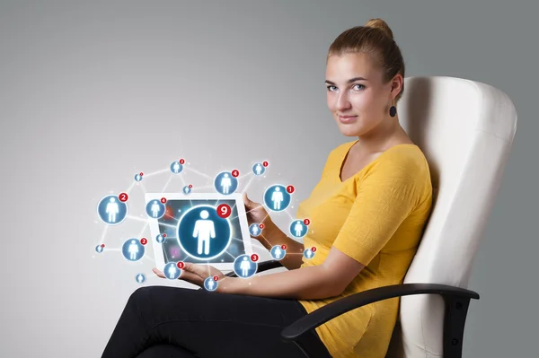 Young woman holding tablet with social network icons — Stock Photo, Image