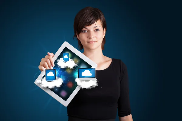 Jovem mulher segurando tablet com dispositivos modernos em nuvens — Fotografia de Stock