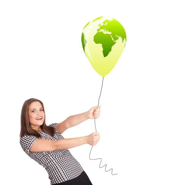 Happy lady holding a green globe balloon — Stock Photo, Image