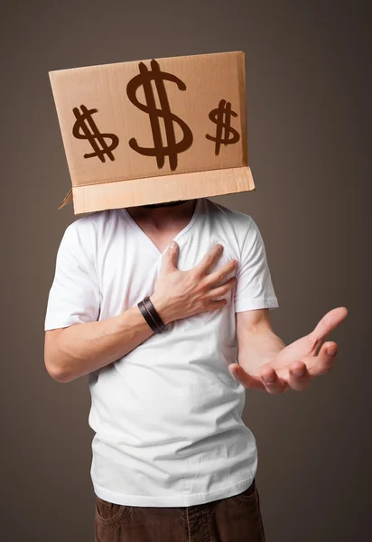 Young man gesturing with a cardboard box on his head with dollar — Stock Photo, Image