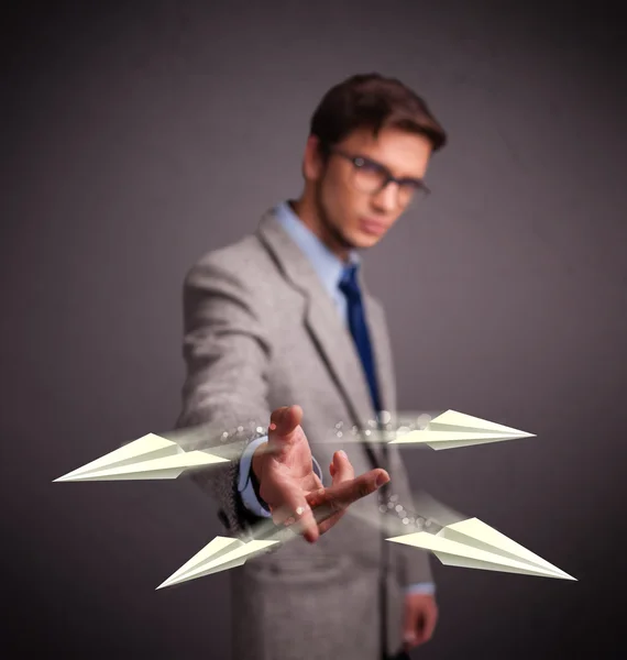 Handsome man throwing origami airplanes Royalty Free Stock Photos