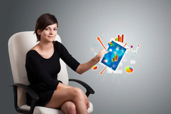 Woman holding modern tablet with colorful diagrams and graphs — Stock Photo, Image