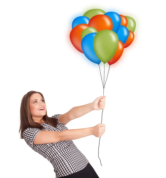 Молодая женщина держит цветные воздушные шары — стоковое фото