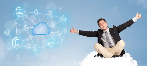 Happy businessman sitting on cloud with cloud computing — Stock Photo, Image