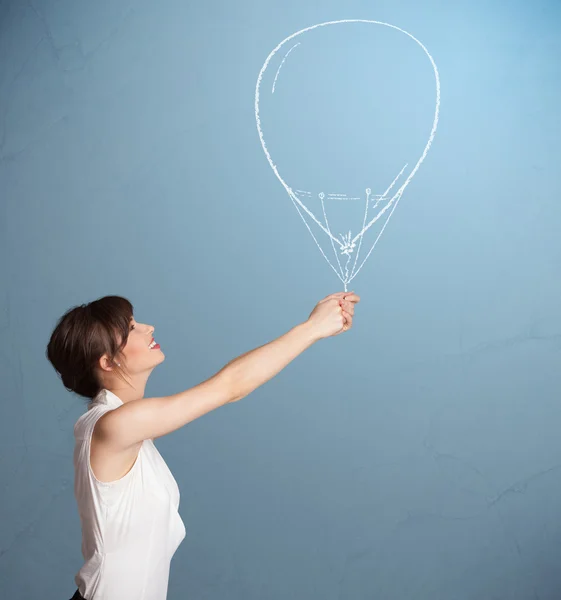 Beautiful woman holding balloon drawing — Stock Photo, Image