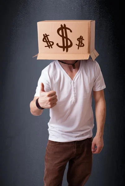 Young man gesturing with a cardboard box on his head with dollar — Stock Photo, Image