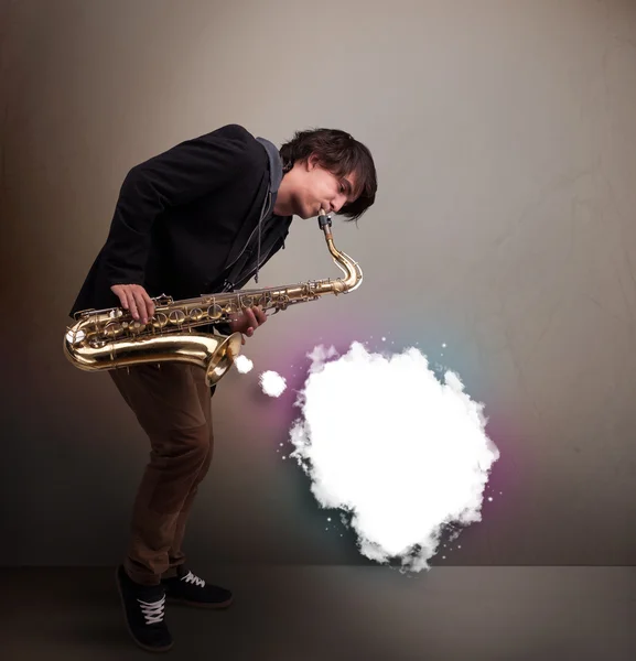 Young man playing on saxophone with copy space in white cloud — Stock Photo, Image