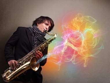 Attractive musician playing on saxophone with colorful abstract