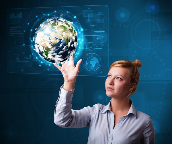 Young buinesswoman touching high-tech 3d earth panel — Stock Photo, Image