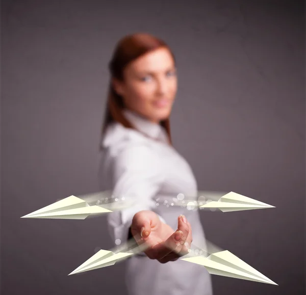 Beautiful lady throwing origami airplanes — Stock Photo, Image