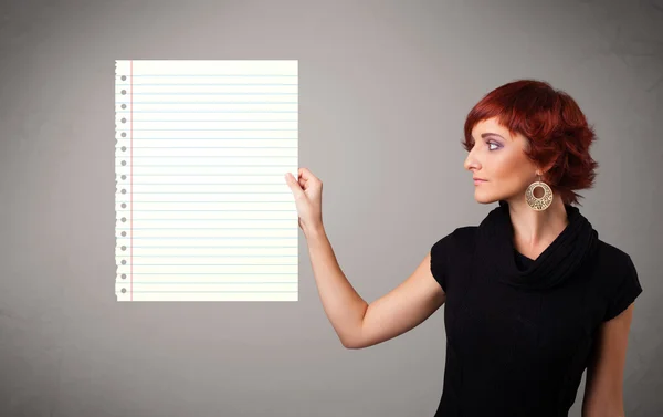 Young woman holding white paper copy space with diagonal lines — Stock Photo, Image