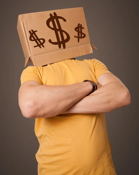 Young man gesturing with a cardboard box on his head with dollar — Stock Photo, Image