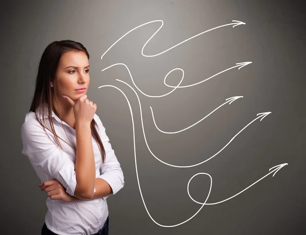 Attractive teenager looking at multiple curly arrows — Stock Photo, Image