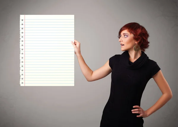 Young woman holding white paper copy space with diagonal lines — Stock Photo, Image