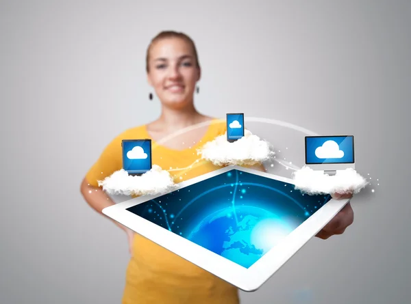 Young woman holding tablet with modern devices — Stock Photo, Image
