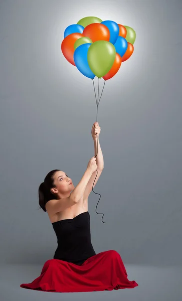 Giovane donna che tiene palloncini colorati — Foto Stock