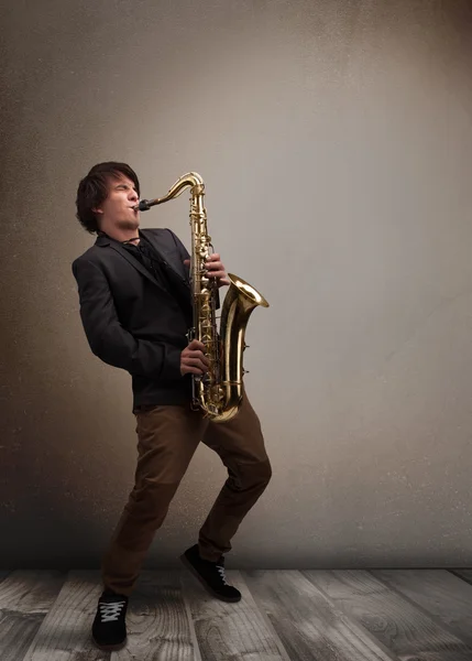 Young musician playing on saxophone — Stock Photo, Image