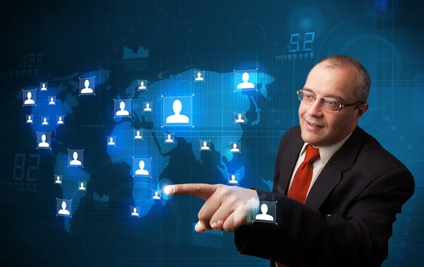 Businessman choosing from social network map — Stock Photo, Image