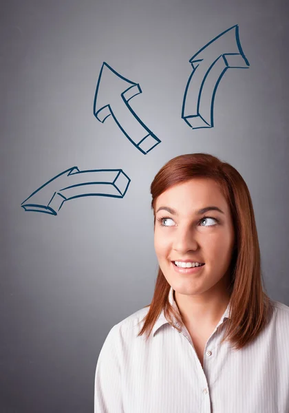 Pretty lady thinking with arrows overhead — Stock Photo, Image