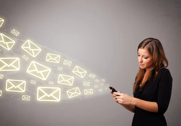 Aantrekkelijke jonge dame met een telefoon met bericht pictogrammen — Stockfoto