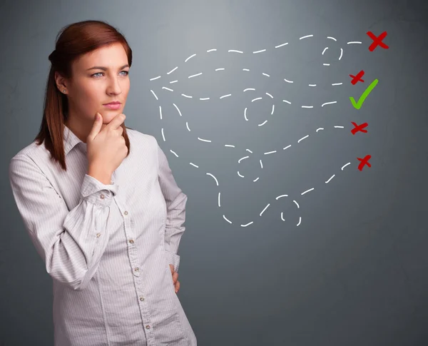 Jonge vrouw die kiest tussen goede en slechte tekens — Stockfoto