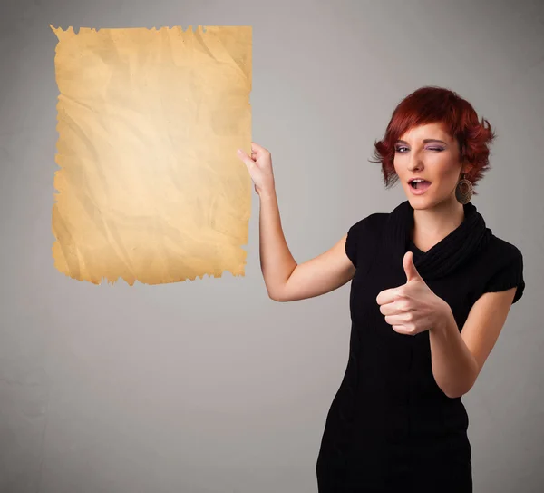 Young girl presenting old paper copy space — Stock Photo, Image