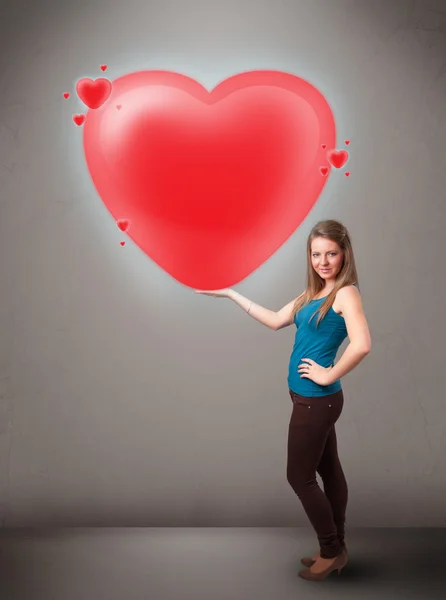 Fiatal hölgy kezében szép 3d piros szív — Stock Fotó
