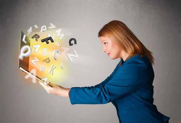 Junge Frau hortet Notizbuch mit bunten abstrakten Buchstaben — Stockfoto